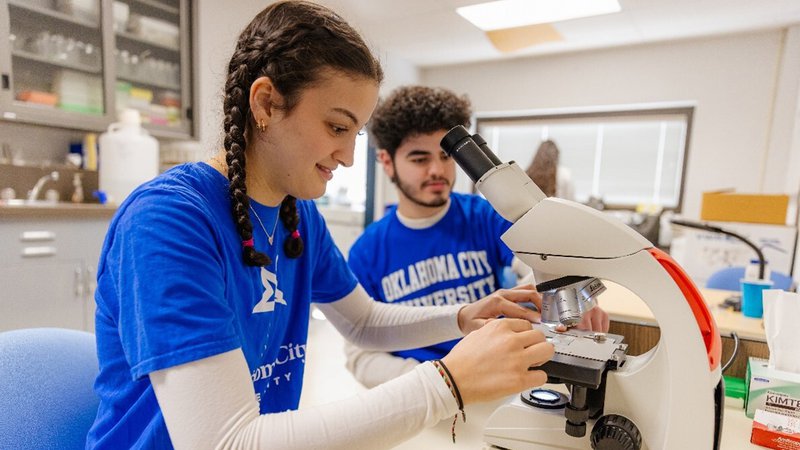 Students in the lab microscope