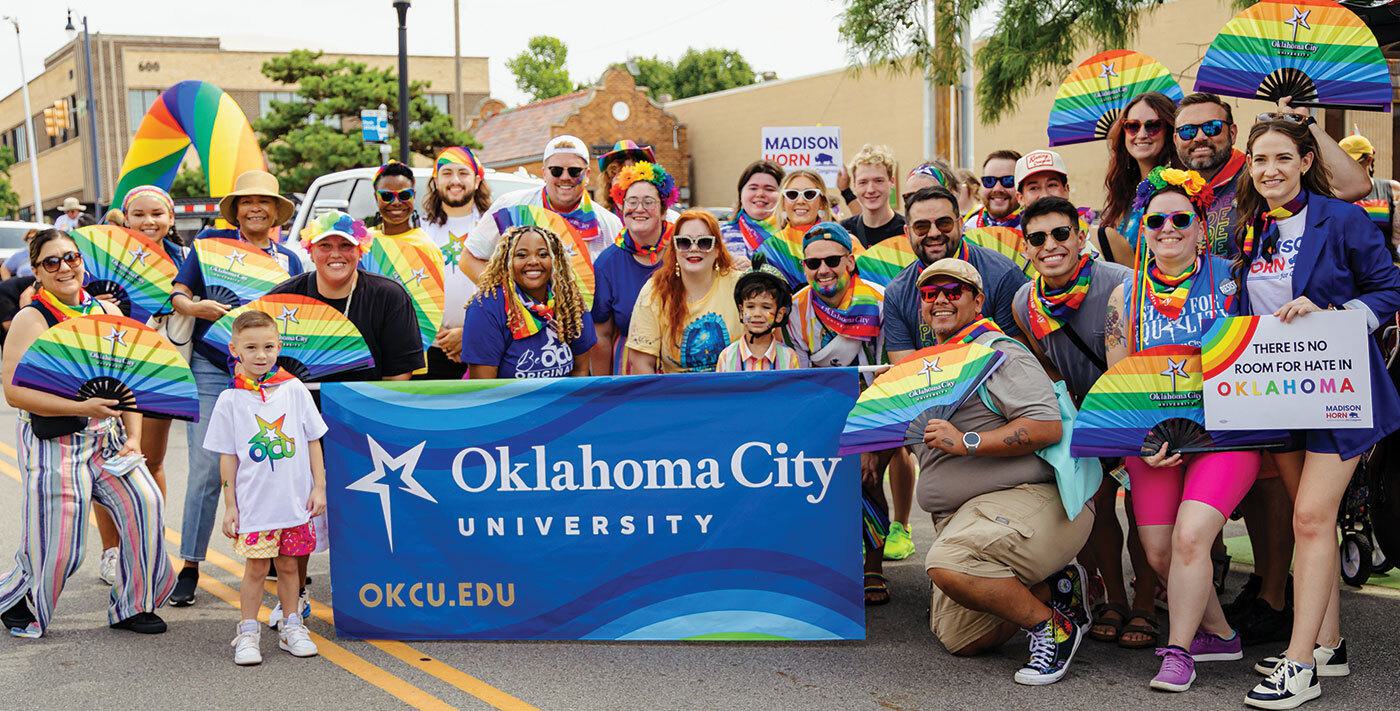 Group holding ³ûÖÊÓÆµ banner at pride parade