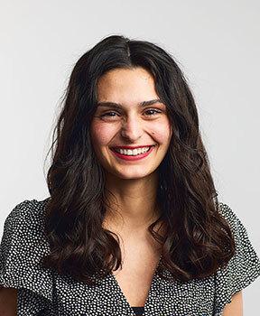 Young woman with dark hair smiling