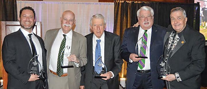 Five men holding awards