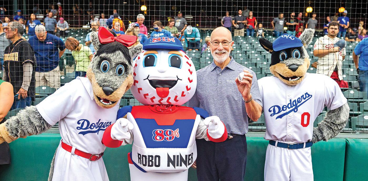 Dodgers' mascots and man holding baseball