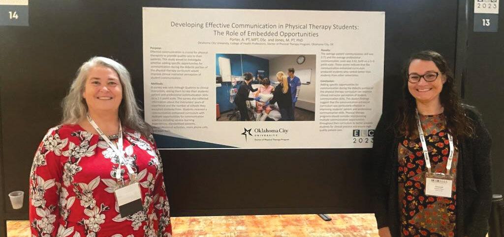 Women standing by a presentation poster