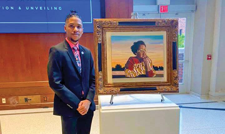 Man standing next to framed painting