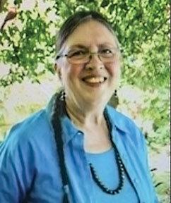 Woman in glasses and blue blouse smiling