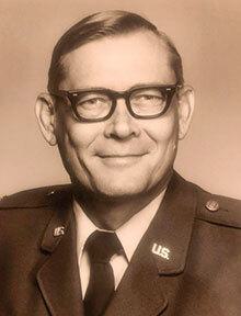 Man in uniform and black glasses smiling