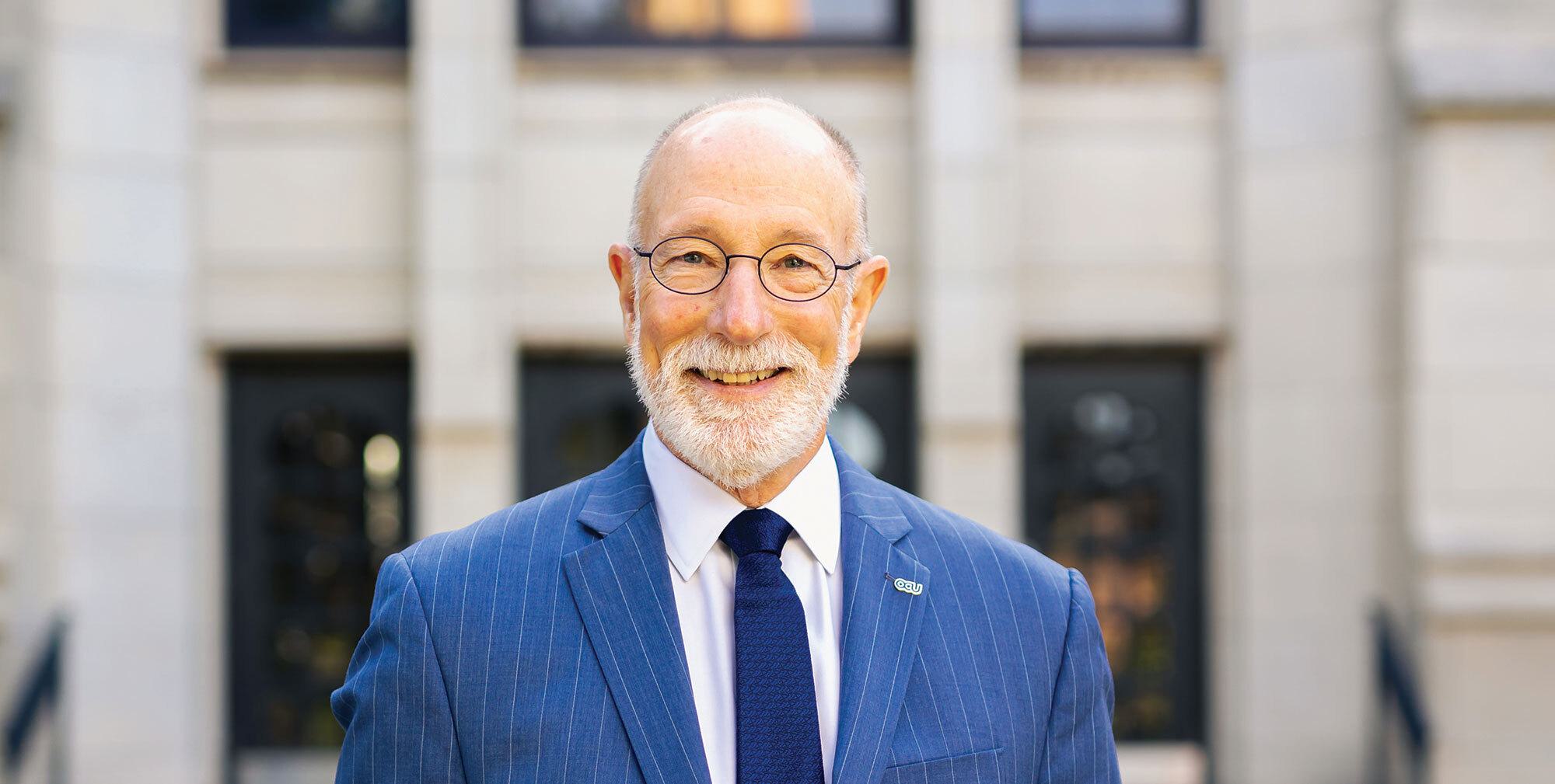Man in blue suit smiling