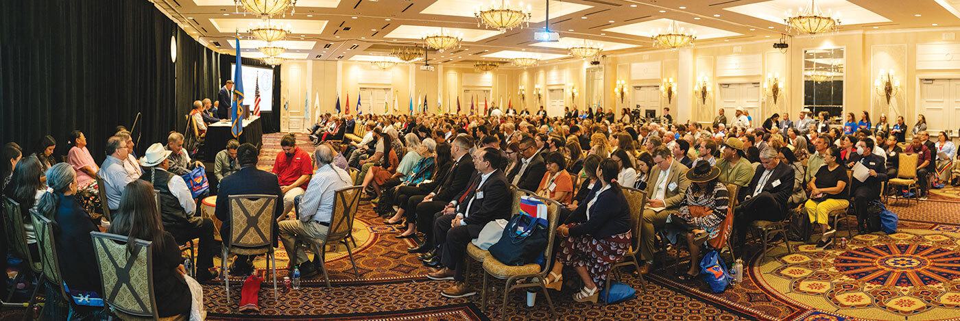 People seated at symposium
