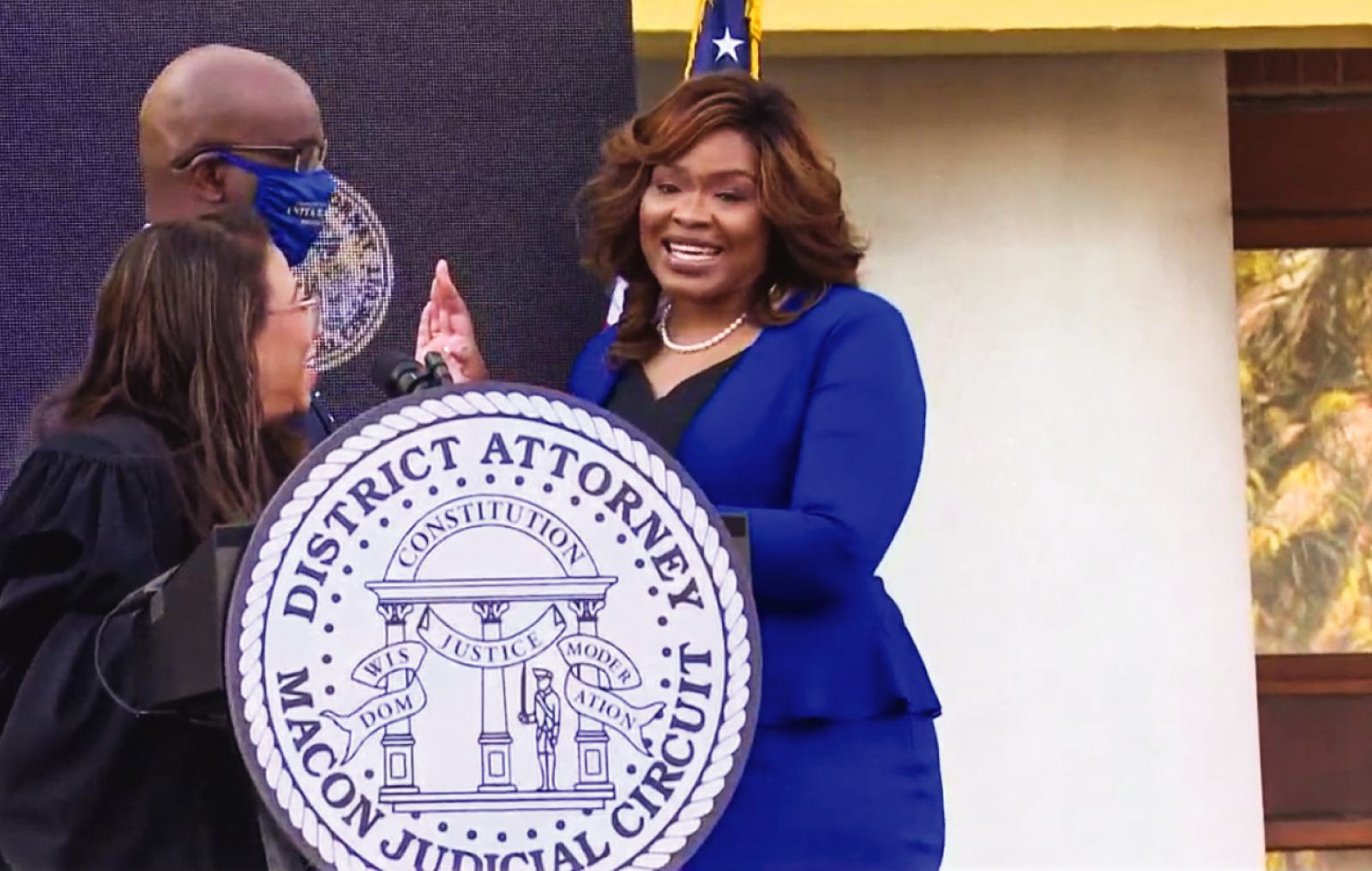Woman in blue suit with two other people