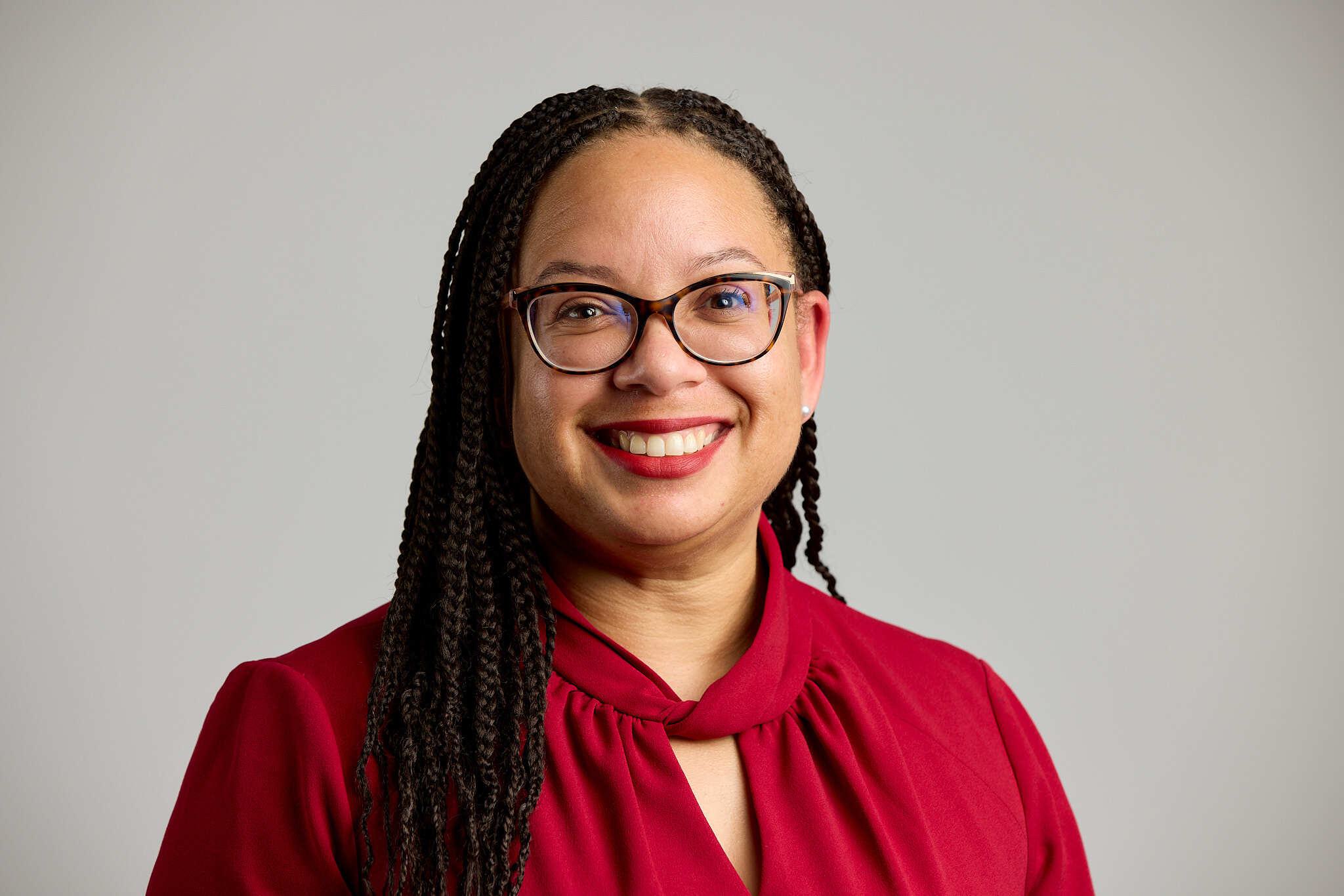 Vice President Dr. Talia Carroll wearing glasses and smiling